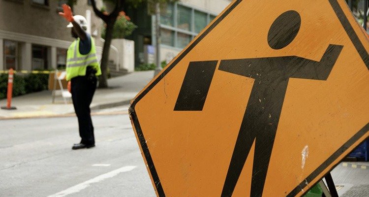 Traffic control person directing traffic at an urban work zone